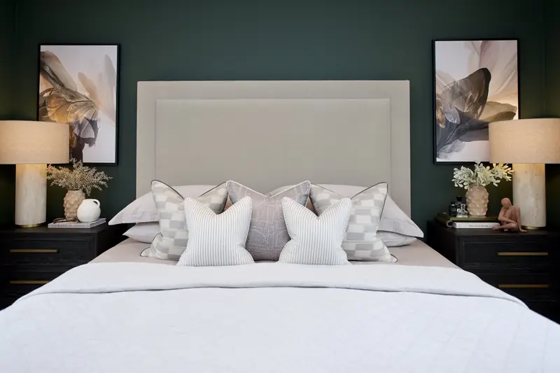 Styled bedroom with layered cushions, lamps and artwork by My Bespoke Room