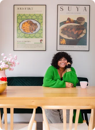 Client smiling at her dining table in a room designed by My Bespoke Room