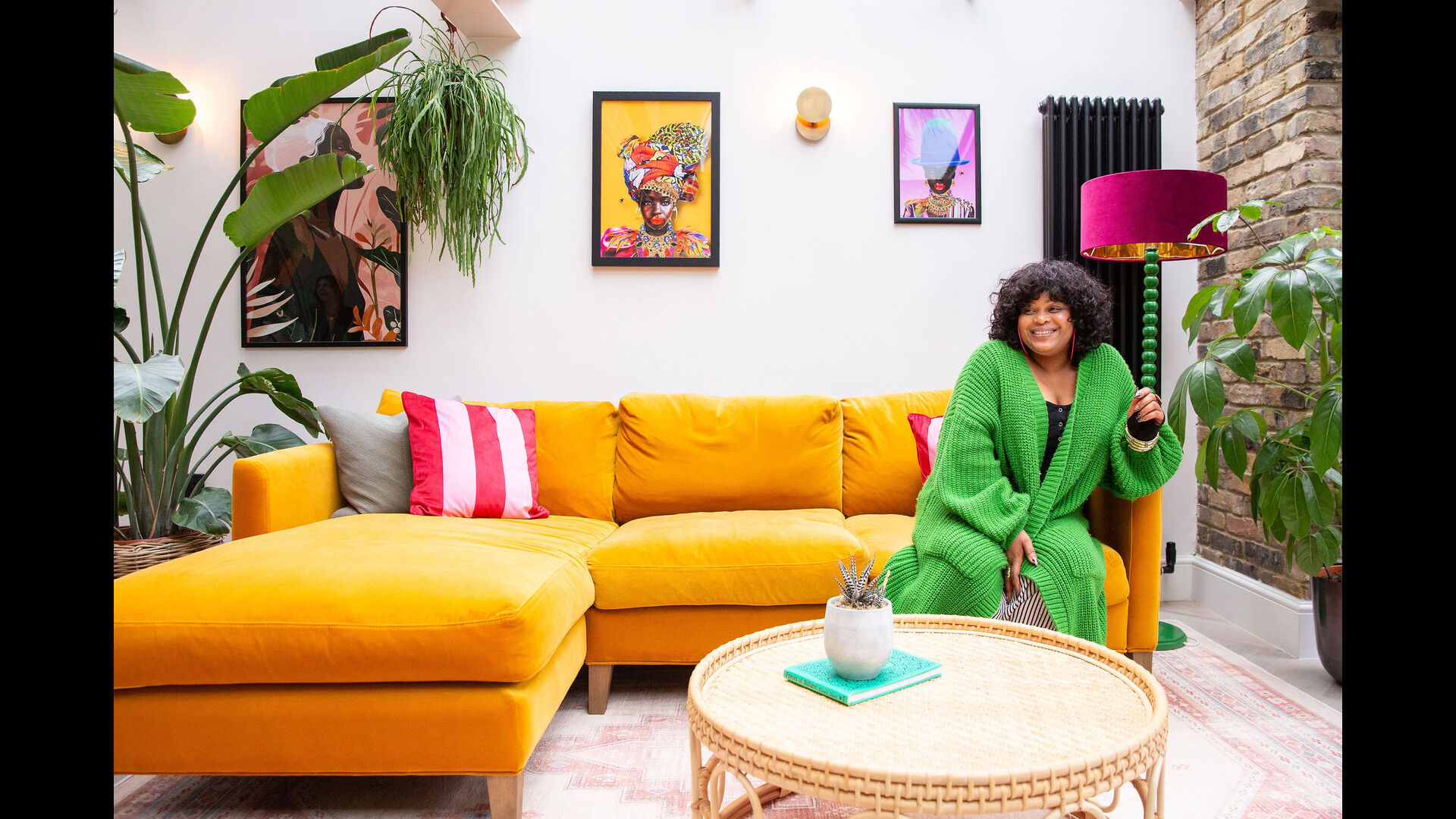 Woman on yellow sofa with plants