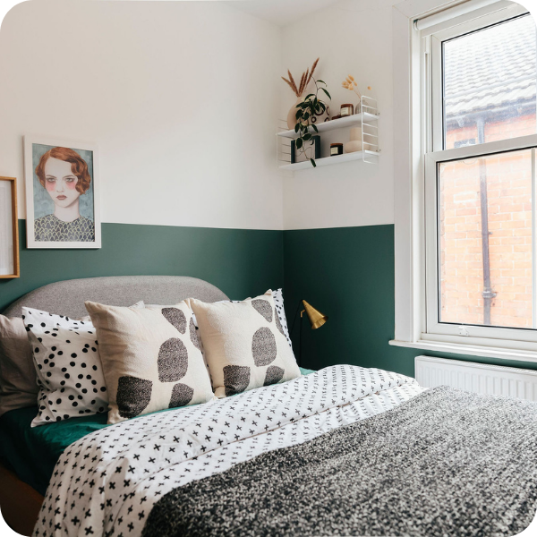 small bedroom with half painted green wall